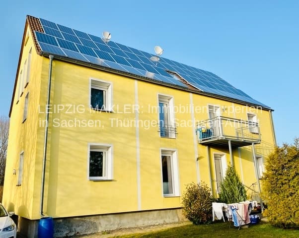 Zweigeschossiges Wohnhaus mit gelber Fassade, Satteldach mit Solarpanelen, Dewitzer Straße in Leipzig-Taucha