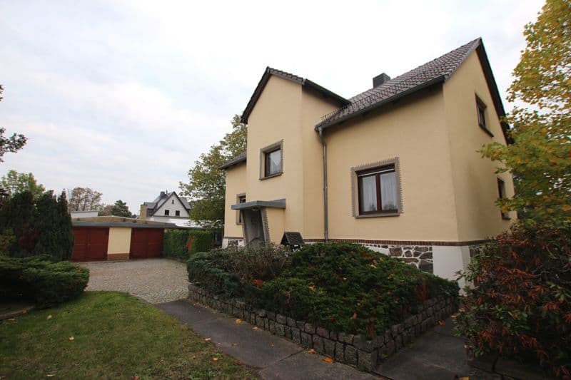 Zweistöckiges Einfamilienhaus mit beiger Fassade, Satteldach, Natursteinsockel, Leipziger Straße in Machern