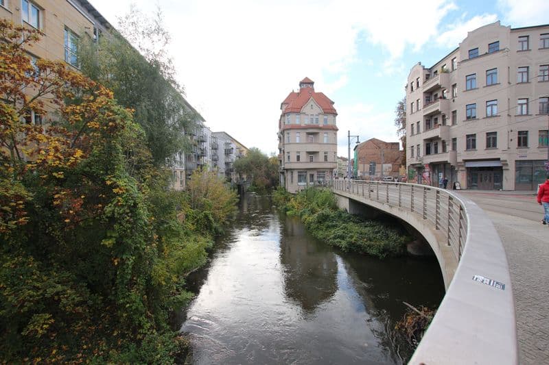 Flussufer mit Efeu bewachsenen Altbauten links, Brücke über Fluss, Mansfelder Straße in Halle
