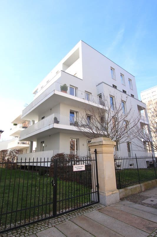 Vierstöckiges Wohngebäude mit weißer Putzfassade, umlaufenden Balkonen und flachem Dach, Beethovenstraße in Leipzig