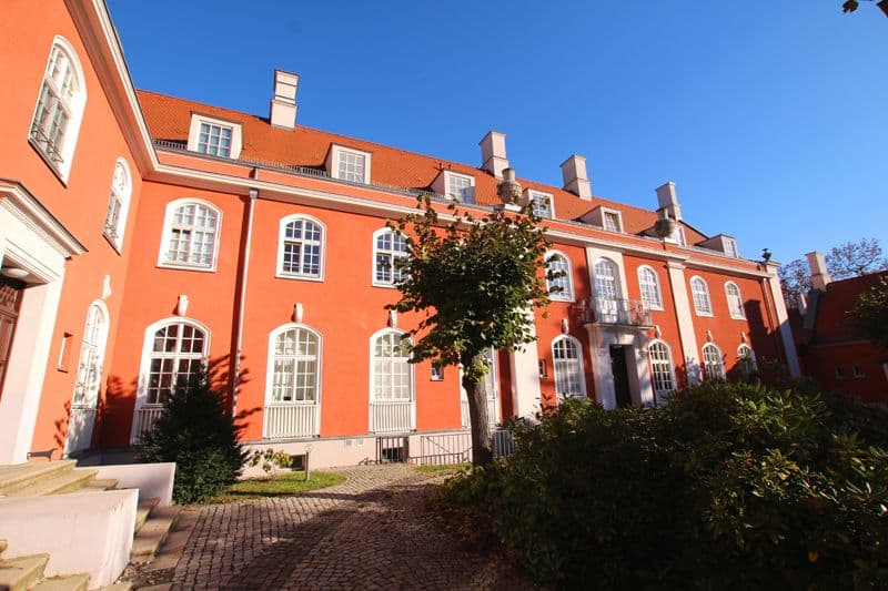 Mehrgeschossiges Backsteingebäude mit orangeroter Fassade, Paul-Michael-Straße in Leipzig-Leutzsch