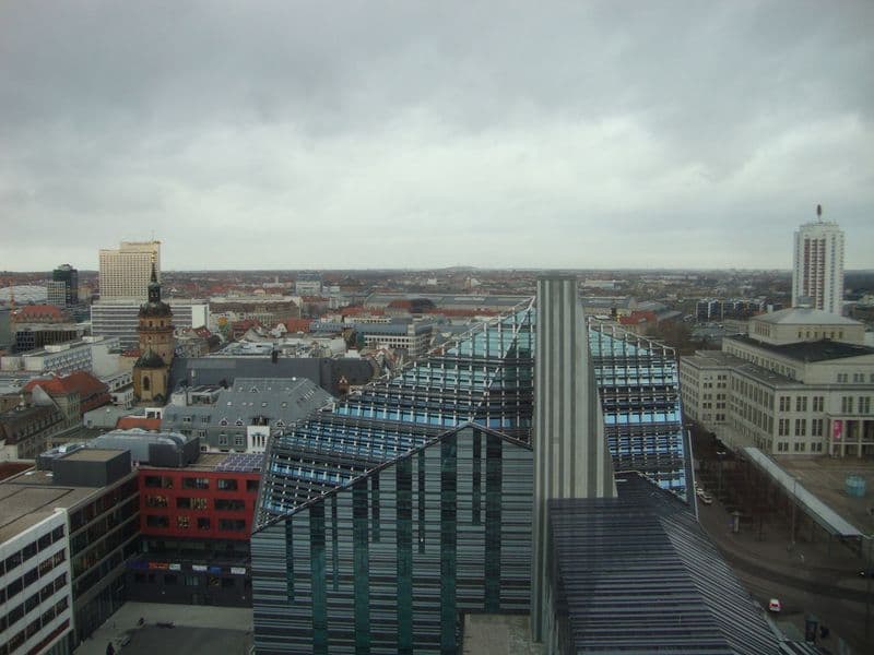 Modernes Gebäude mit Glasfassade und vertikalen Metallstützen, Augustusplatz in Leipzig